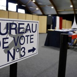 This picture taken on June 12, 2022 shows a placard at the entrance of a polling station for the French parliamentary elections in Le Touquet, northern France. (Photo by Ludovic MARIN / AFP)
